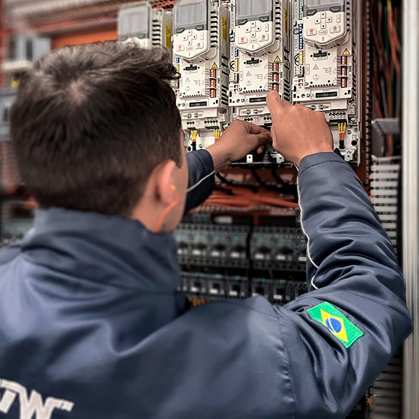 Engenheiro eletricista mexendo em painel elétrico industrial